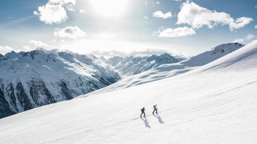 two man hiking on snow mountain